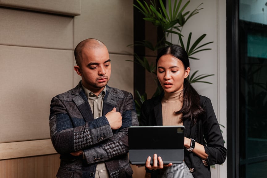 Business Partners Discussing with Tablet